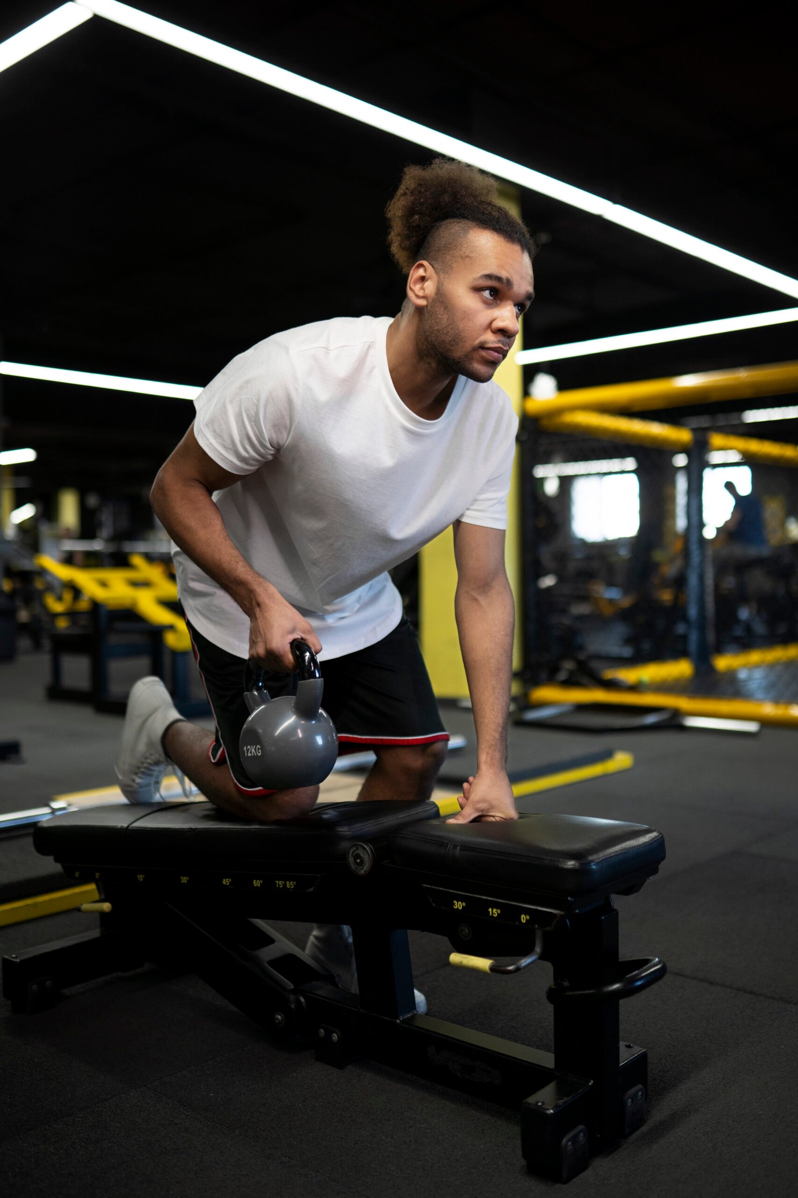 full-shot-man-exercising-with-kettlebell