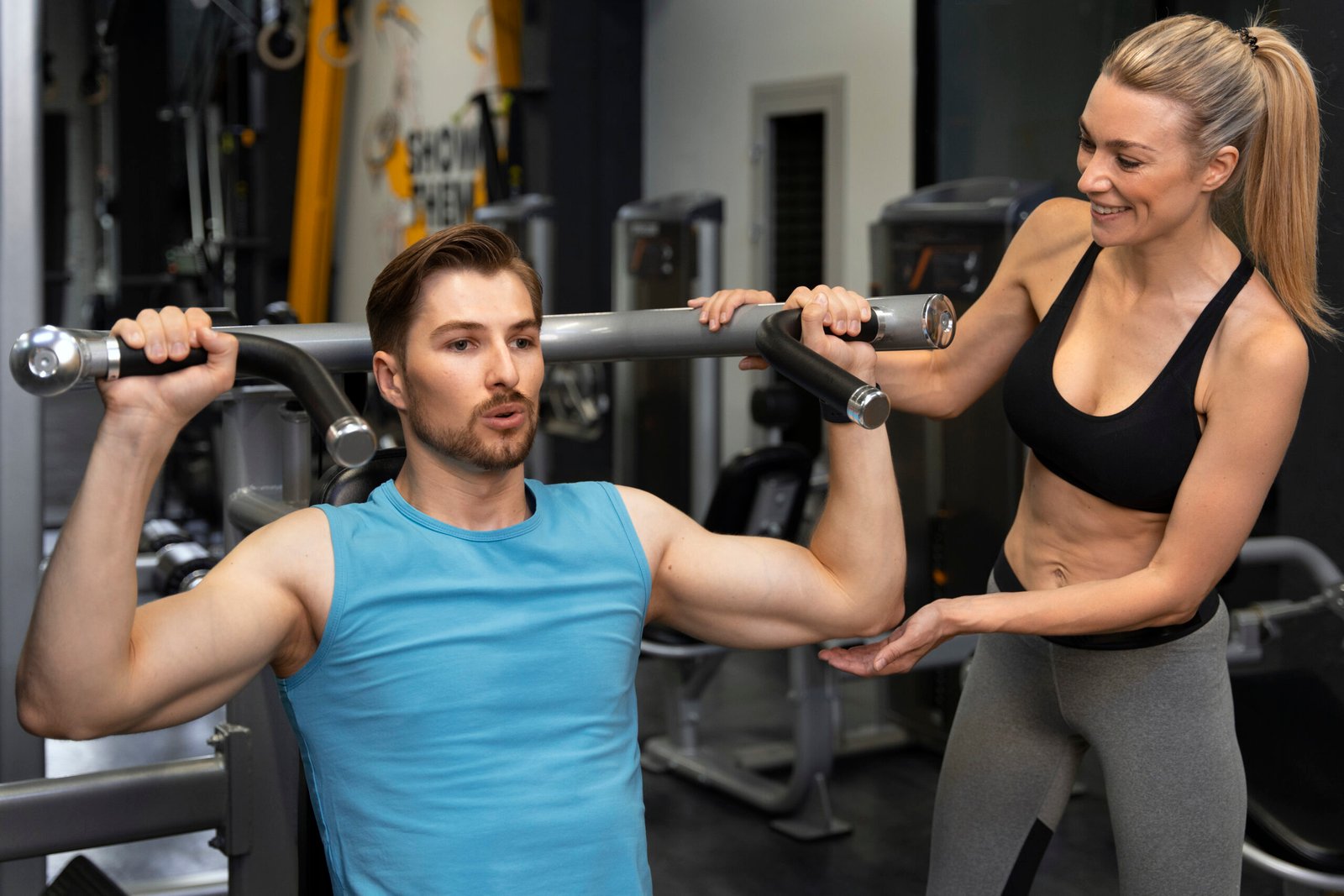 trainer-helping-beginner-gym