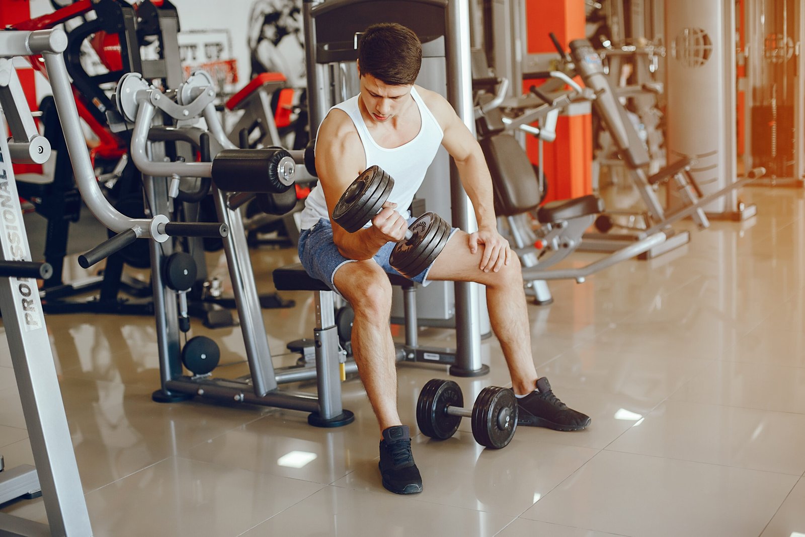 A young and athletic boy is engaged in sports in the gym